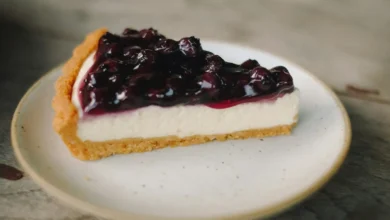 Şekersiz çiğ raw vegan cheesecake tarifi, kaju kremalı tabanlı ve orman meyveli fırınsız pasta dilimi sunumu